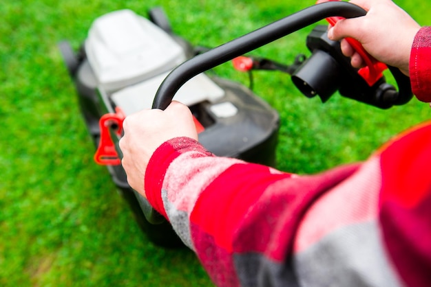 lawn mower green grass with sun light garden man holding mower dressed red shirt hous 699690 487